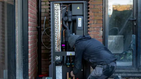 Andrew Aitchison/Getty Images Air source heat pump being installed into a 1930's built house on the 29th of November 2024 near Ashford United Kingdom.