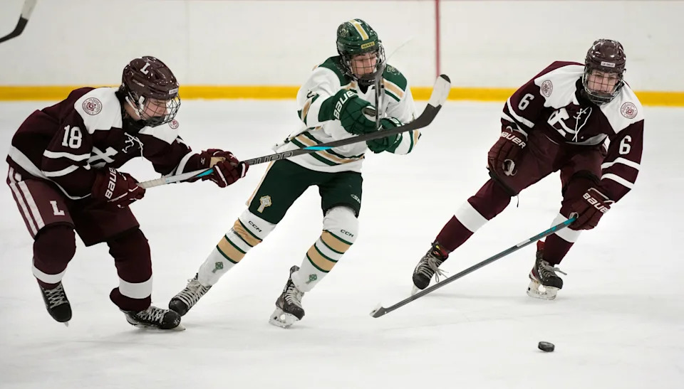 Hendricken defenseman Sebastian Nault spits La Salle players Shane Gaudreau and Tucker Cobery during first period action.